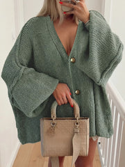 Buttoned Blouse in green, featuring oversized sleeves and chic design, paired with a stylish handbag.