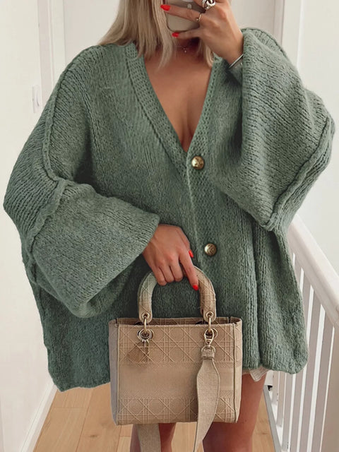 Buttoned Blouse in green, featuring oversized sleeves and chic design, paired with a stylish handbag.