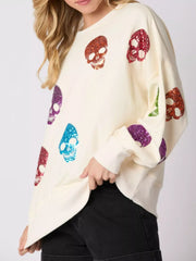 Halloween Colorful Skull Sequin Oversized Sweatshirt with multi-color skull sequins on a cream background.
