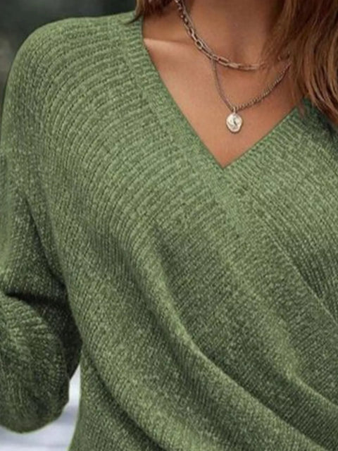 Close-up of a woman's Surplice Long Sleeve Knit Top in green featuring a ribbed texture and V-neckline.