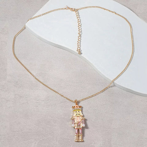 18K Gold Nutcracker Pendant Necklace featuring rhinestone charm on delicate gold chain.