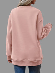 Back view of a woman wearing a pink Letter Graphic Round Neck Sweatshirt with long sleeves.
