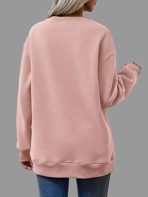 Back view of a woman wearing a pink Letter Graphic Round Neck Sweatshirt with long sleeves.