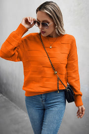Classic Round Neck Loose Knit Sweater in vibrant orange color, worn with sunglasses and jeans for a casual look.