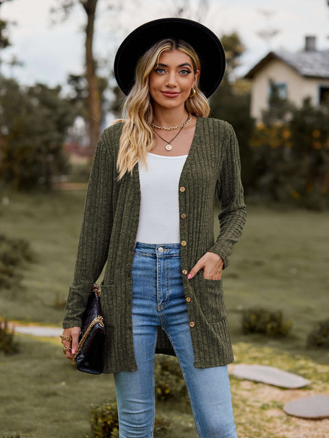 Woman wearing a Ribbed Button-Up Cardigan with Pockets, styled with jeans and accessories in a scenic outdoor setting.