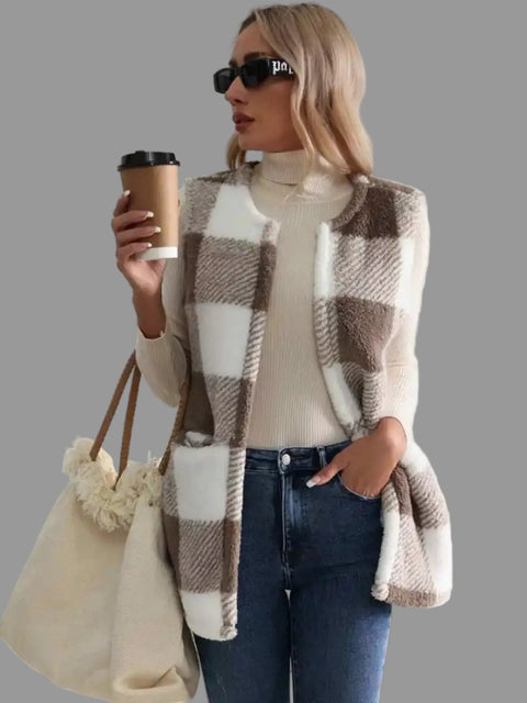 Woman in plaid sherpa vest coat holding a coffee cup, styled for effortless everyday fashion.
