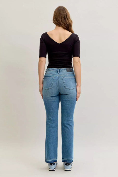 Back view of a woman wearing Judy Blue High-Waist Straight Leg Jeans with tummy control feature.