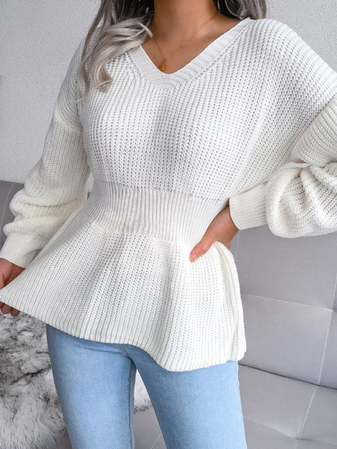 Model wearing a V-Neck Dropped Shoulder Sweater with a ribbed texture and peplum design in white.
