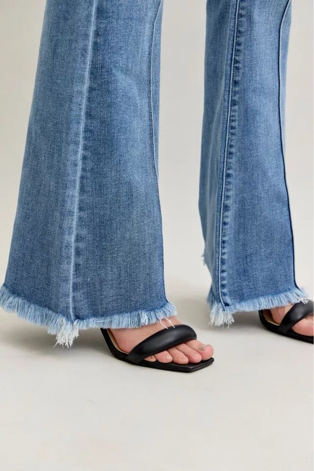 Close-up of Judy Blue High Waist Flare Fray Hem Jeans with Pintuck Detail showcasing the frayed hem and fashionable fit.