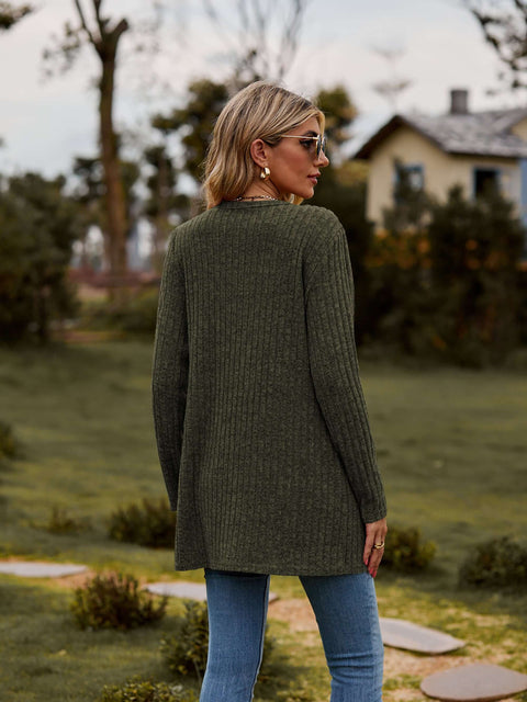 Ribbed Button-Up Cardigan with Pockets in green, styled casually outdoors, showcasing its cozy, long sleeve design.