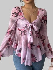 Floral Tie-Front Blouse with pink floral patterns, v-neckline, and tie detail, showcasing romantic and feminine style.