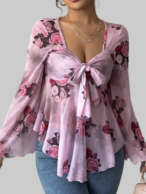 Floral Tie-Front Blouse with pink floral patterns, v-neckline, and tie detail, showcasing romantic and feminine style.