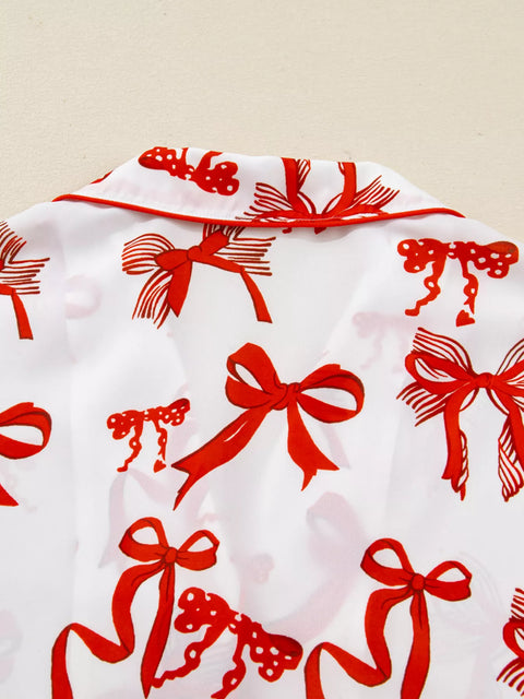 Buttoned Two-Piece Set featuring red bow design on a white background, showcasing a stylish and chic pattern.