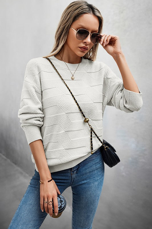 Woman wearing a Classic Round Neck Loose Knit Sweater with sunglasses and a crossbody bag.