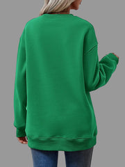Back view of a woman wearing a green Letter Graphic Round Neck Sweatshirt, showcasing the relaxed fit and comfort.