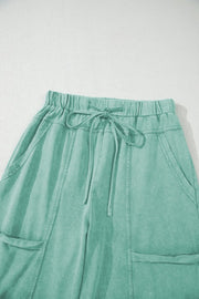 Mineral Wash Reverse Seam Drawstring Elastic Waist cargo pants in mint green with adjustable waistband and pockets.