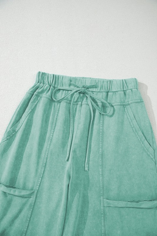 Mineral Wash Reverse Seam Drawstring Elastic Waist cargo pants in mint green with adjustable waistband and pockets.