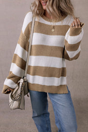 Woman wearing the Arabella Striped Side-Slit Knit Sweater with bold color-block stripes and relaxed fit.