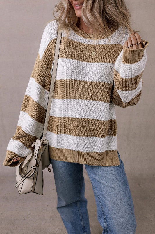 Woman wearing the Arabella Striped Side-Slit Knit Sweater with bold color-block stripes and relaxed fit.