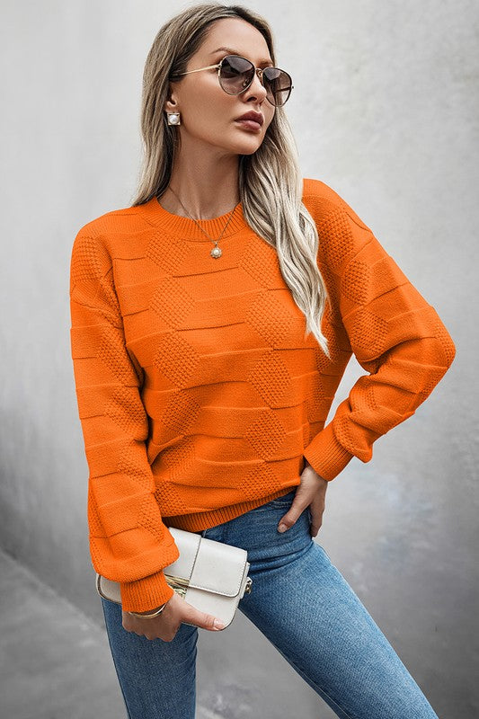 Classic Round Neck Loose Knit Sweater in vibrant orange with relaxed fit, paired with jeans and accessories.