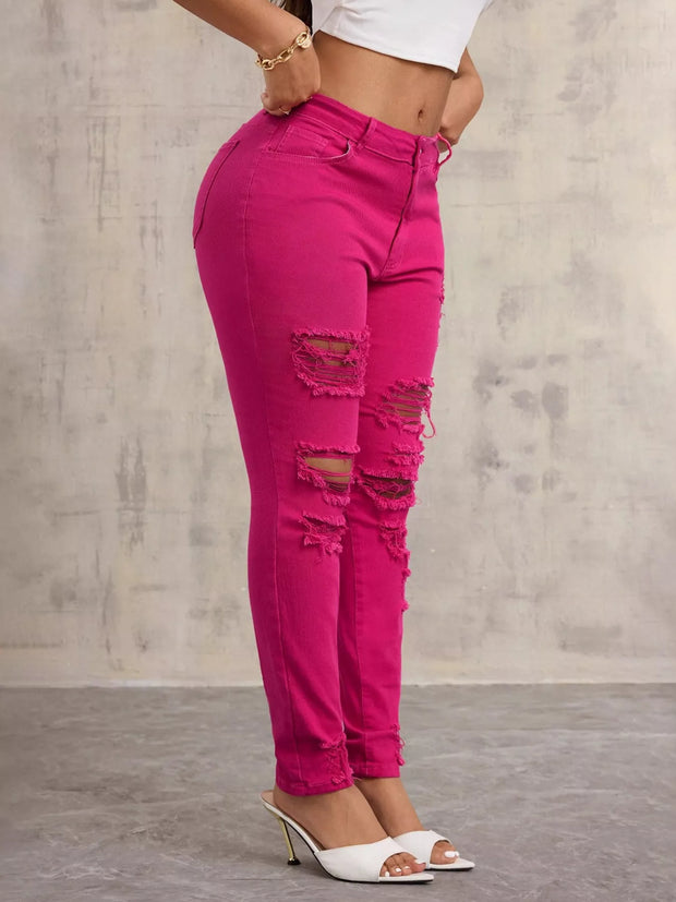 High-Waisted Distressed Skinny Jeans – Classic Denim Fit in vibrant pink with distressed details and a flattering fit.