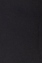 Close-up view of the textured fabric of the Mandy Plaid Collared Jacket in black.