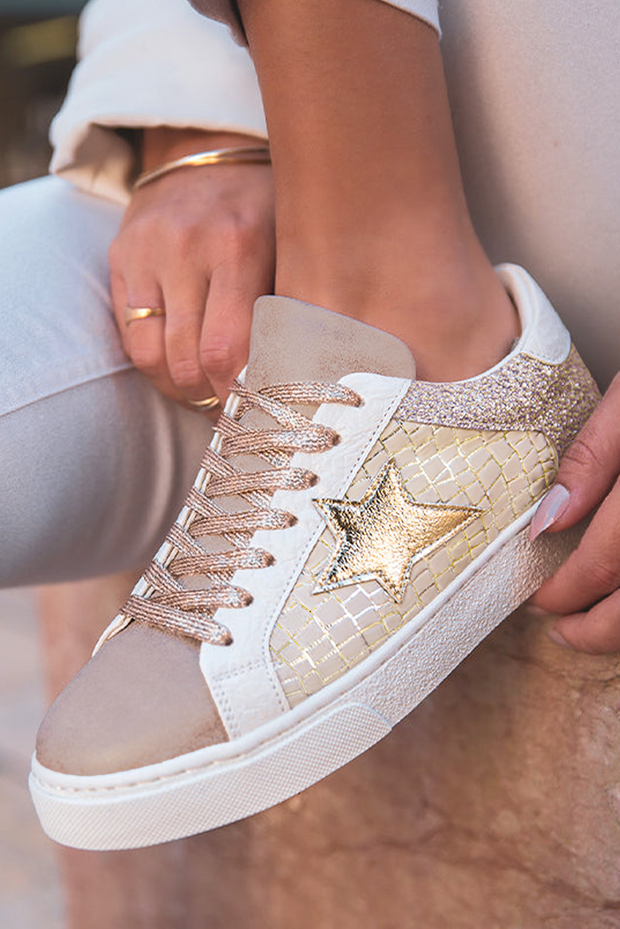 Stylish gold glitter star patchwork PU leather lace-up sneakers on a fashionable foot, showcasing trendy design and glittery accents.