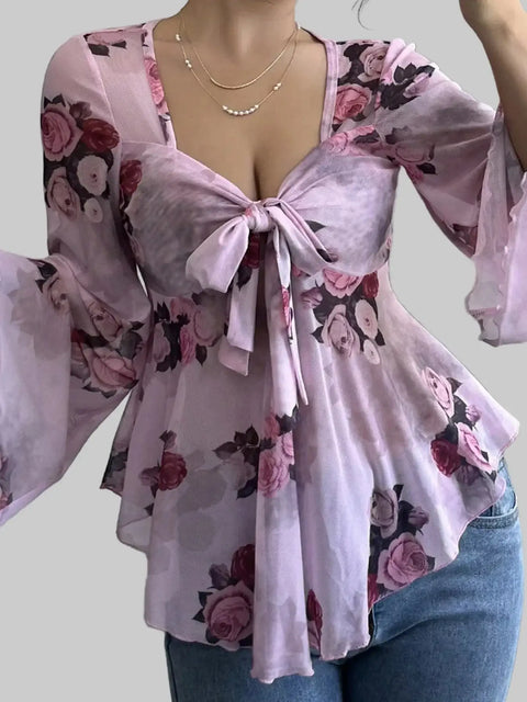 Floral Tie-Front Blouse featuring a flattering v-neckline and fluttery sleeves in a romantic pink floral print.