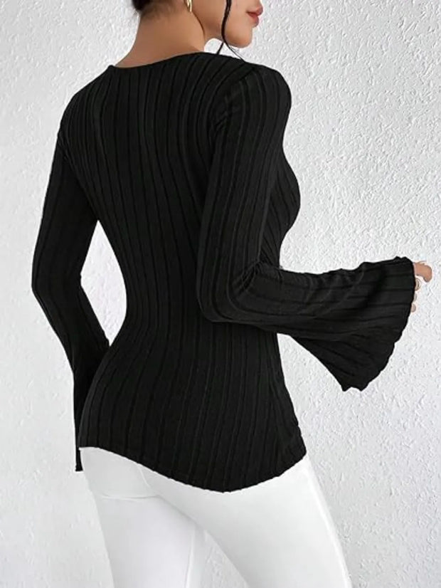 Back view of a woman wearing a Ribbed Flare Sleeve Top, showcasing its ribbed texture and flare sleeves.