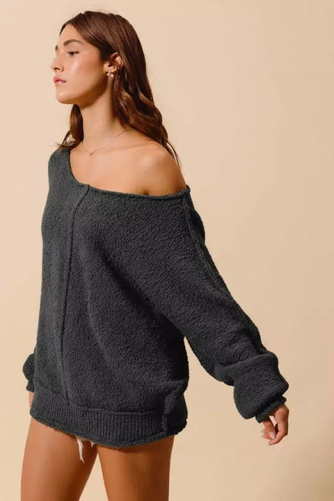 Model wearing the So Me Slouchy Bouclé Sweater in dark gray, showcasing its relaxed fit and cozy texture.