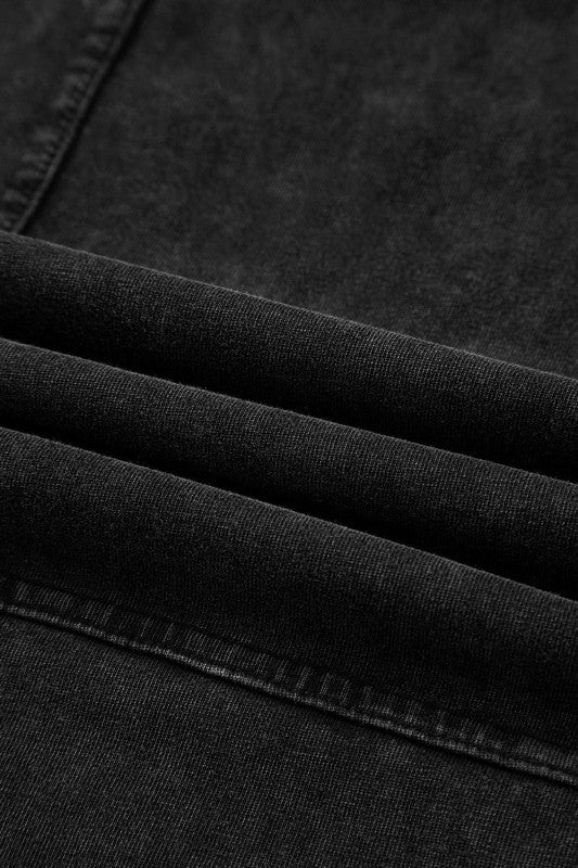 Close-up of the fabric detail of Mineral Wash Reverse Seam Drawstring Elastic Waist cargo pants in black.