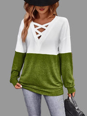 Model wearing Crisscross V-Neck Color Block Top in white and green with a stylish hat.