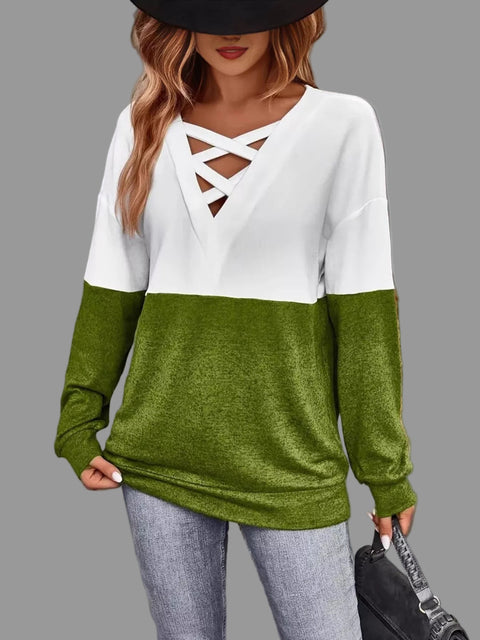 Model wearing Crisscross V-Neck Color Block Top in white and green with a stylish hat.