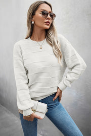 Fashion model wearing Classic Round Neck Loose Knit Sweater with sunglasses and jeans, showcasing casual style.