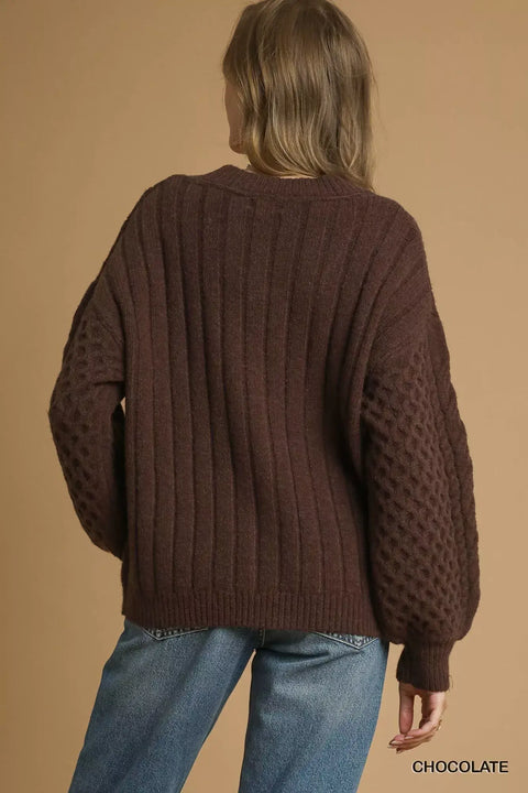 Pearl Button Cable Knit Cardigan in chocolate color, featuring textured knitting and a relaxed fit, viewed from the back.