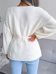 Back view of a woman wearing a V-Neck Dropped Shoulder Sweater in white with ribbed peplum design.