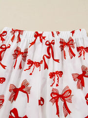 Buttoned Two-Piece Set featuring red ribbon patterns on white fabric for a playful, chic design.
